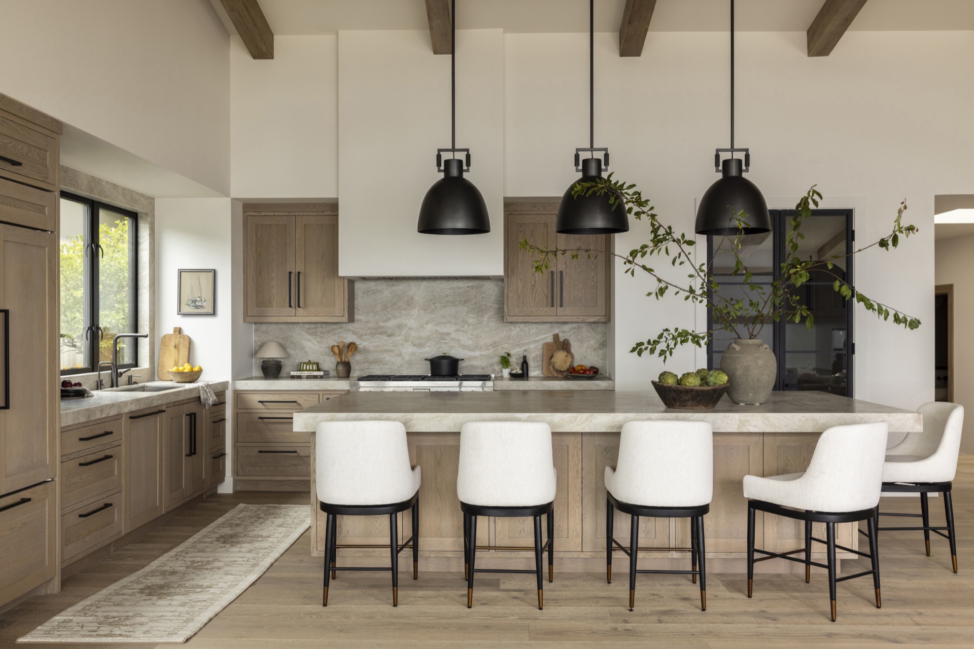 Coastal Urban, the kitchen with black pendants over a stone island