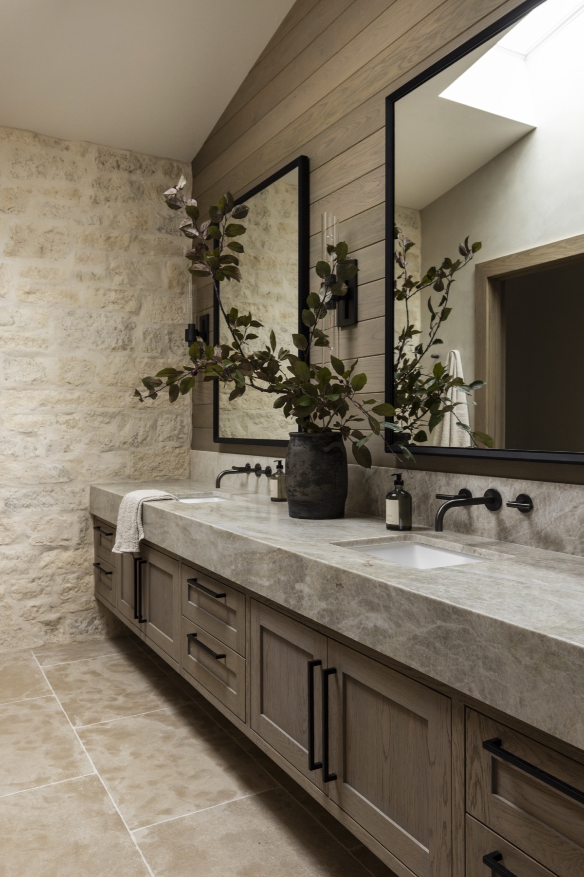 Coastal Urban, the primary bath double vanity against a limestone wall