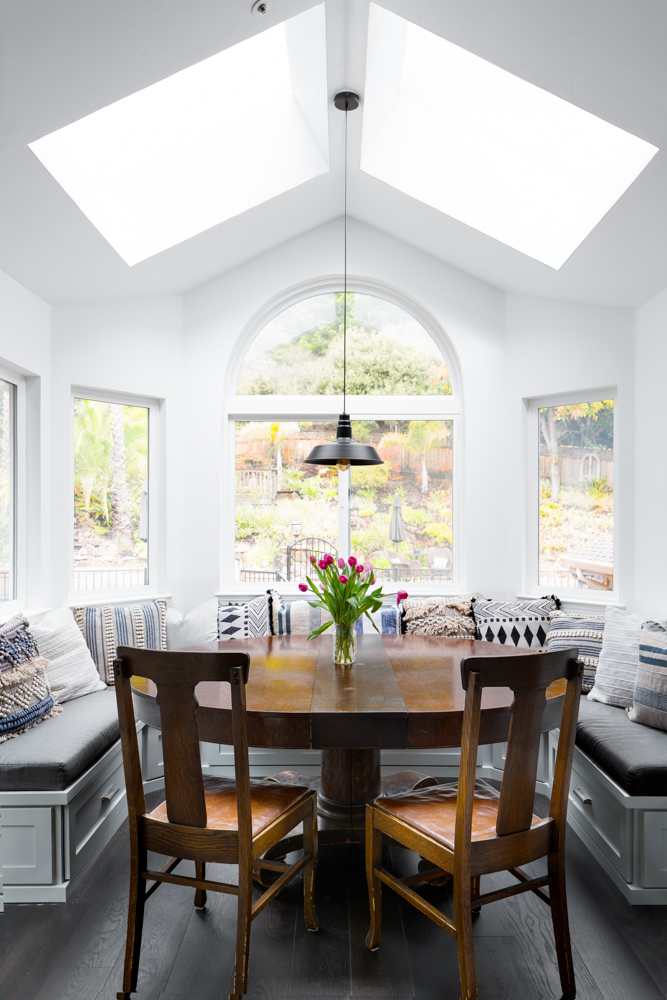 Modern Bungalow, the breakfast nook: skylights and an arched window over wraparound bench seating.