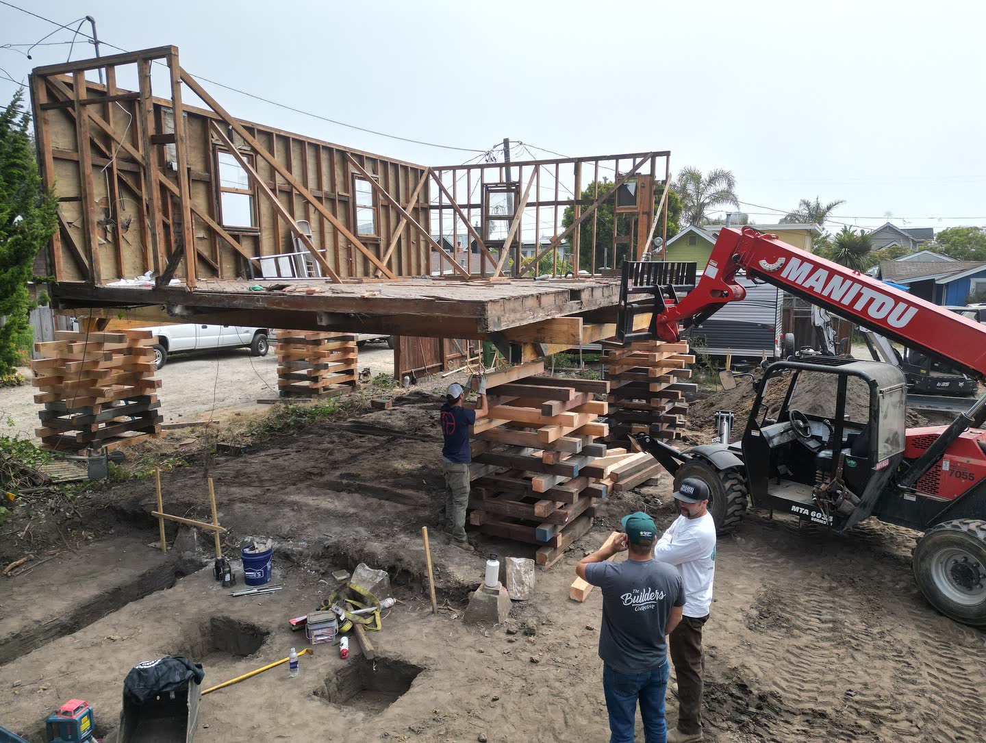 The crew lifting a whole house on cribbing for a new foundation.